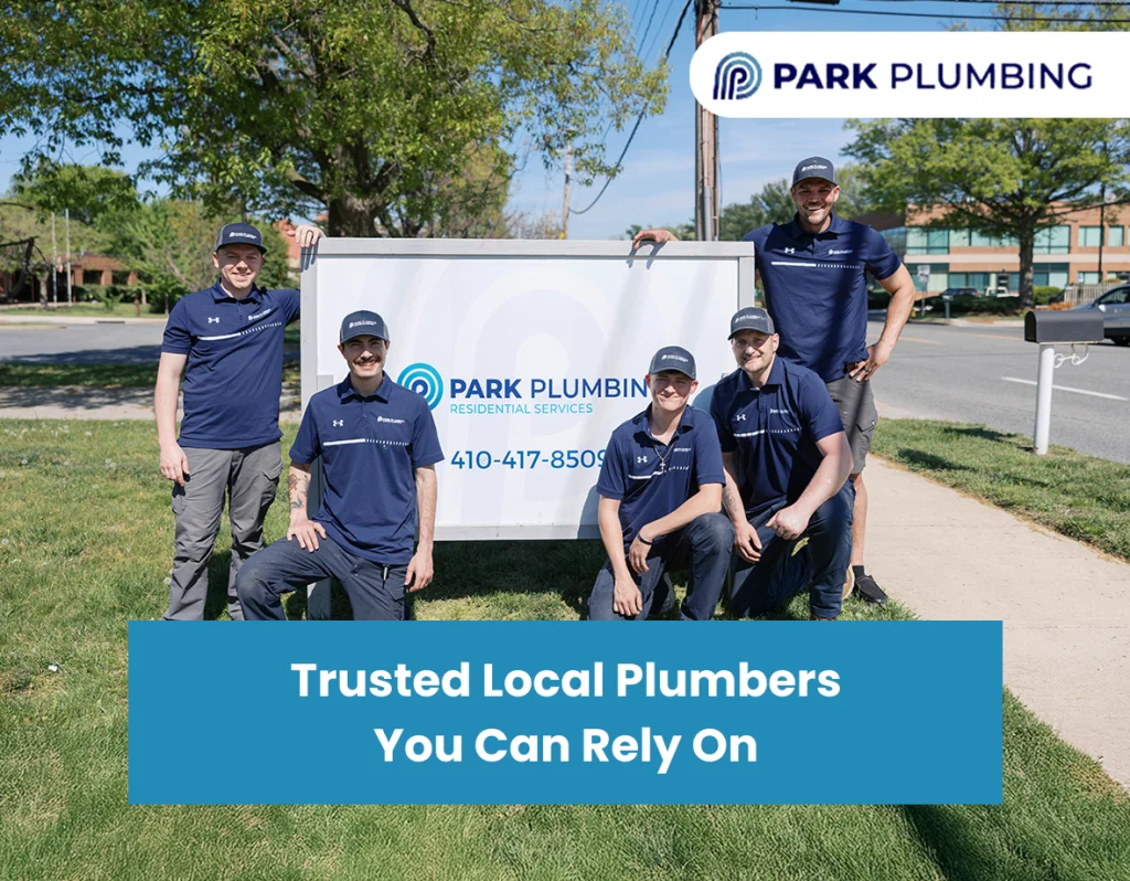 Professional plumber from Park Plumbing assisting a homeowner with plumbing repairs in a residential kitchen.
