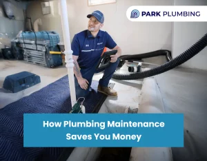 Plumber performing routine plumbing maintenance by inspecting pipes and fixtures in a modern home bathroom.